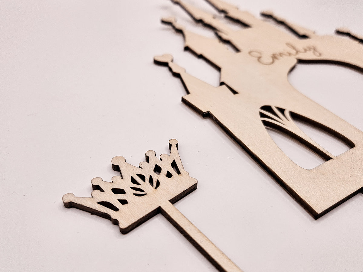 Personalisierter Cake Topper aus Holz für einen Prinzessinnen-Geburtstag mit Schloss, Krone, Sternen sowie individuellem Namen und Alter des Geburtstagskindes. Der Tortenstecker eignet sich als besondere Kuchendeko für Mädchen und ergänzt eine Prinzessinnen-Mottoparty oder einen Kindergeburtstag. Die feinen Holzdetails und das märchenhafte Schlossmotiv machen den personalisierten Geburtstagstorten-Topper zum Blickfang auf Kuchen und Torte.