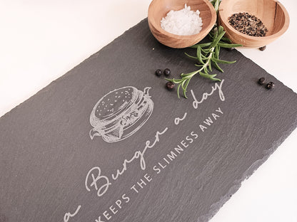 Schieferplatte mit Abbildung eines Burgers und dem Text: a Burger a day keeps the slimmness away