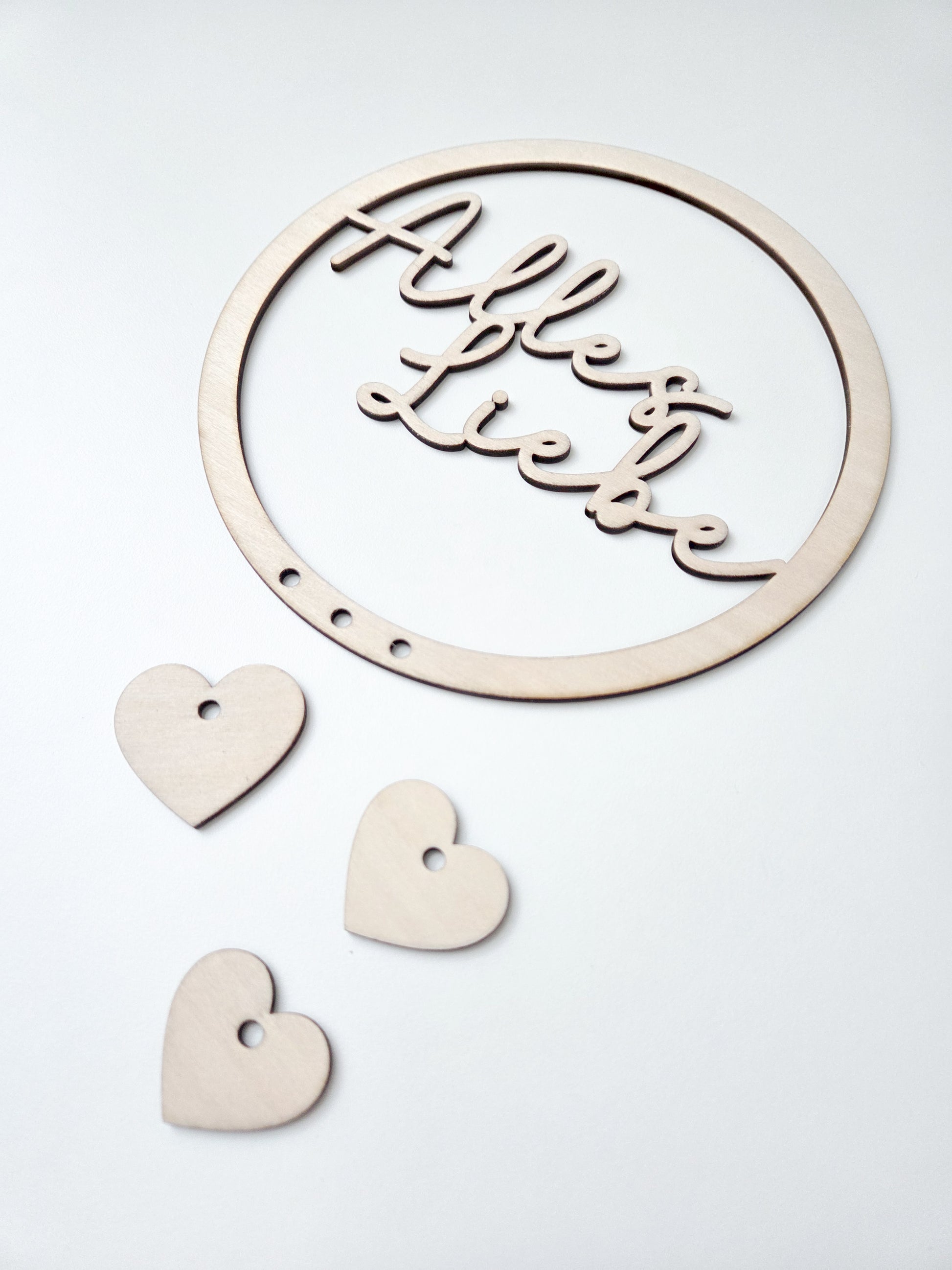 Personalisierter Holzring mit Name als Blumenkranz Einsatz im Skandi Stil, filigraner Schriftzug aus Holz für Trockenblumen Kranz Deko, Türkranz personalisiert mit Herz Anhängern, natürlicher Holz Schriftzug für DIY Kranz, modernes Türschild mit Namen, Geschenkidee Einzug Hochzeit Familie, Kranz Schild personalisiert, Boho Wanddeko mit Holzring und Namensgravur, minimalistisches Design, handgemachte Dekoration für Zuhause, individuelle Kranzgestaltung mit Holz Schriftzug und Anhängern