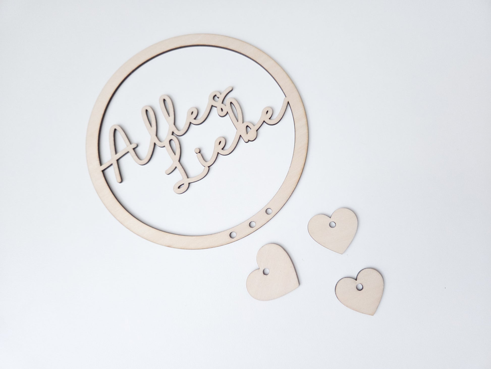 Personalisierter Holzring mit Name als Blumenkranz Einsatz im Skandi Stil, filigraner Schriftzug aus Holz für Trockenblumen Kranz Deko, Türkranz personalisiert mit Herz Anhängern, natürlicher Holz Schriftzug für DIY Kranz, modernes Türschild mit Namen, Geschenkidee Einzug Hochzeit Familie, Kranz Schild personalisiert, Boho Wanddeko mit Holzring und Namensgravur, minimalistisches Design, handgemachte Dekoration für Zuhause, individuelle Kranzgestaltung mit Holz Schriftzug und Anhängern
