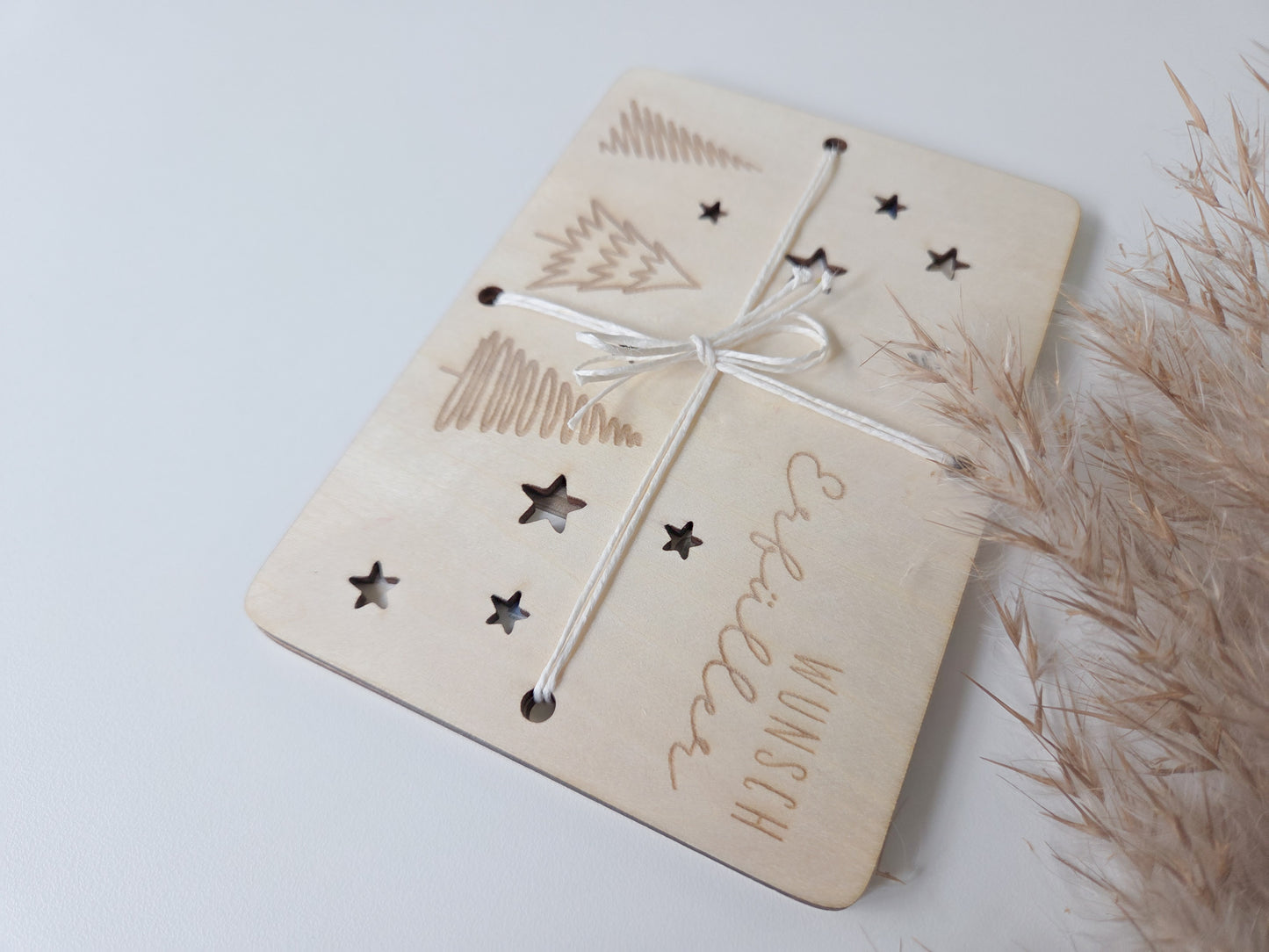 „Wunsch-Erfüller Holzkarte aus hellem Holz mit Tannenbaum-Gravur und Stern-Ausstanzungen – Weihnachts-Geldgeschenk im Scandi-Stil.“