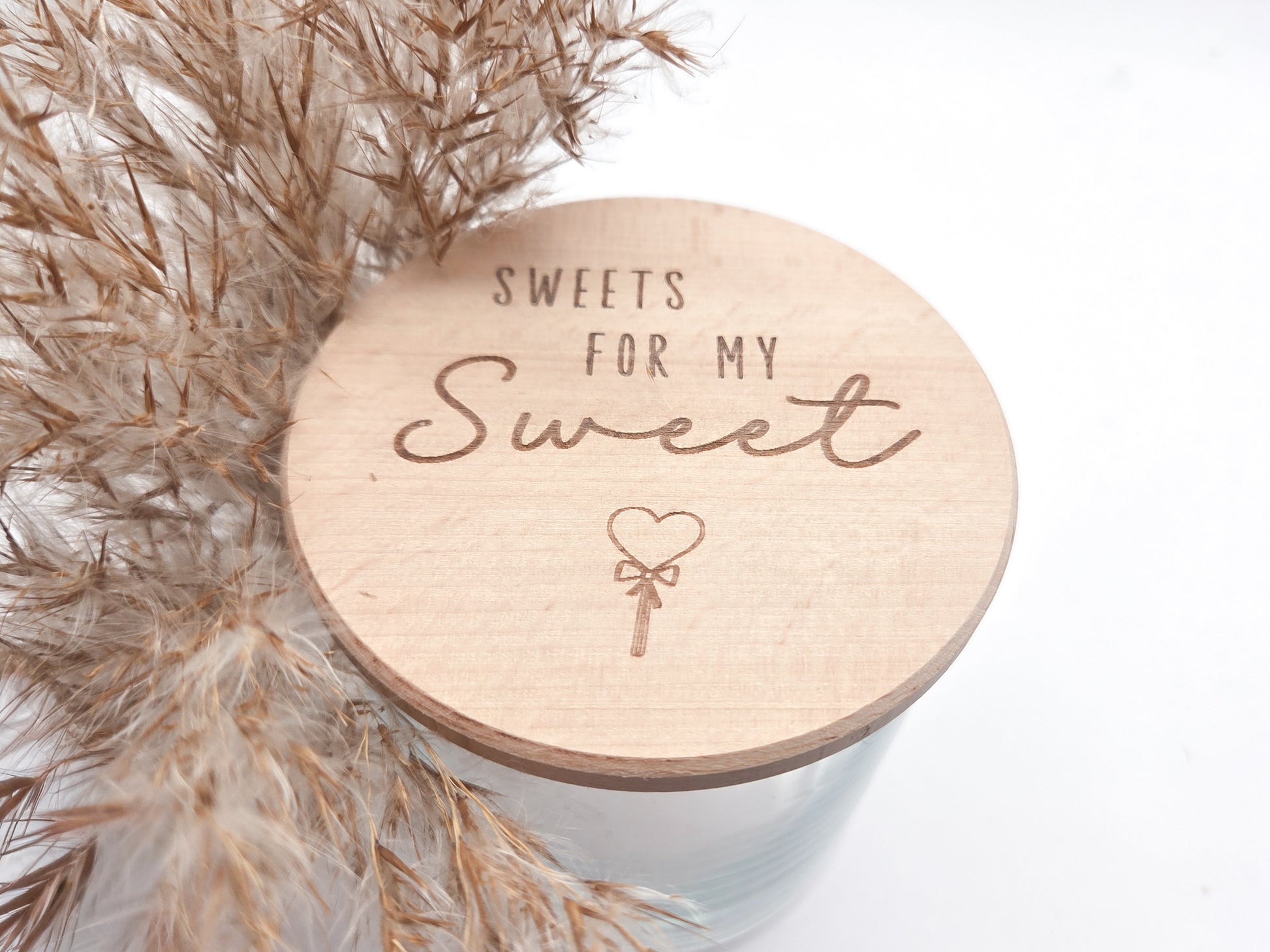 Dekoratives Geschenkglas aus transparentem Glas mit hochwertigem Buchenholzdeckel und liebevoller Lasergravur „Sweets for my Sweet“. Das Glas wird leer geliefert und eignet sich ideal zum individuellen Befüllen mit Süßigkeiten, Pralinen oder kleinen Überraschungen. Zeitloses, minimalistisches Design im Scandi Stil, perfekt als Geschenk zum Valentinstag, Geburtstag, Jahrestag oder für einen Herzensmenschen. Nachhaltig, hochwertig und wiederverwendbar.