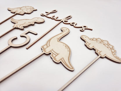 Dino Cake Topper personalisiert aus Holz mit Name und Alter für Dinosaurier Kindergeburtstag Junge. Tortendeko Dinosaurier Set mit Triceratops, T-Rex, Brachiosaurus und Stegosaurus, individueller Namensstecker und Zahl. Hochwertiger Holz Caketopper für Dino Party Deko, Geburtstagstorte Junge 3 4 5 6 Jahre, natürliche Tortendekoration für Naked Cake, Buttercremetorte oder Fondantkuchen. Personalisierte Geburtstagsdeko Holz kaufen bei leoundlu.de.