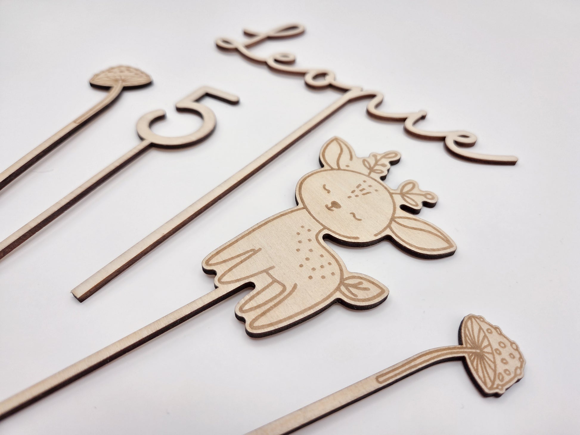 Personalisierter Cake Topper aus Holz mit Name Leonie und Zahl 5 im Waldtiere Design für Kindergeburtstag. Hochwertiger Holz Tortenstecker mit Reh Motiv, graviert und gelasert, perfekte Tortendeko für Naked Cake, Boho Geburtstag, Natur Kinderparty und Scandi Geburtstagsdeko. Nachhaltige Cake Topper personalisiert mit Name und Alter, Waldtier Party Dekoration für Mädchen und Jungen, individuelle Holz Geburtstagsdeko für 1. 2. 3. 4. 5. Geburtstag handgefertigt von Leo&Lu.