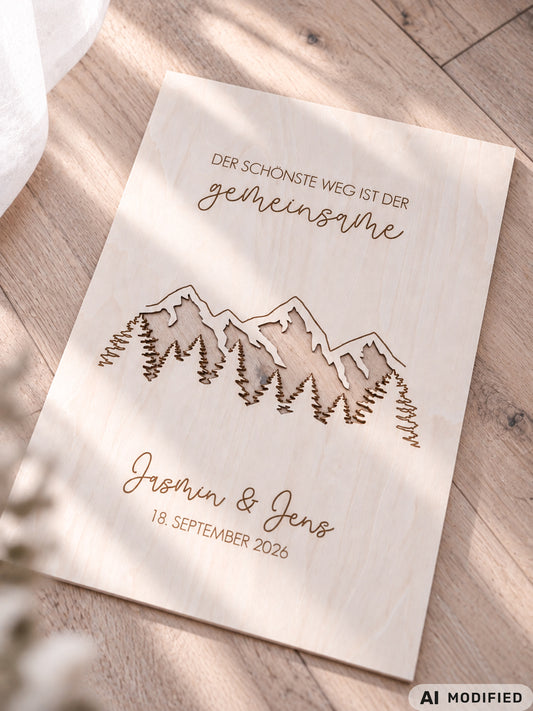 Personalisiertes Geldgeschenk zur Hochzeit aus Holz mit filigran ausgeschnittener Berg- und Waldlandschaft. Hinter den Bergen lassen sich Geldscheine dekorativ platzieren. Mit Gravur „Der schönste Weg ist der gemeinsame“, Namen des Brautpaares und Hochzeitsdatum. Originelles Hochzeitsgeschenk für Braut und Bräutigam, ideal als Geldgeschenk zur Hochzeit, personalisierte Hochzeitsdeko und besondere Geschenkidee für Paare, Bergliebhaber, Wanderfreunde und Naturliebhaber.